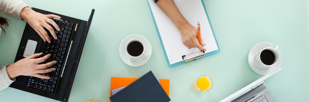 Young team working on laptop computers and writing