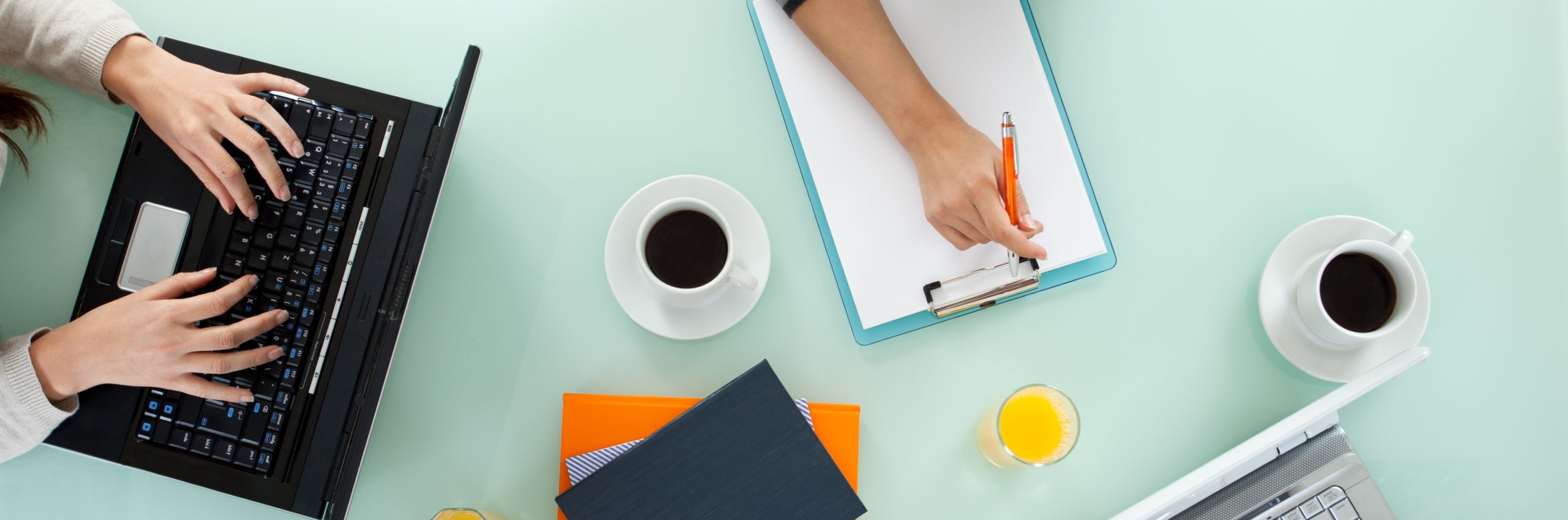Young team working on laptop computers and writing